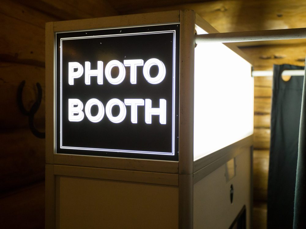 Sign at a wedding reception says photo booth.